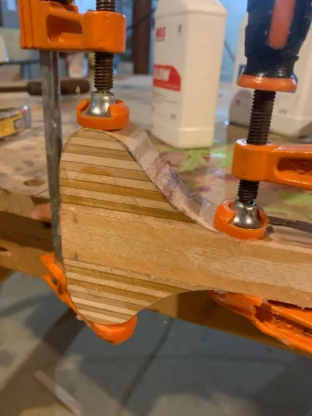 Here are the laminated paddle hand hold pieces being glued to the paddle with epoxy glue.